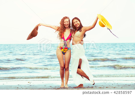 Happy women dance on sand beach in summer. 42858597