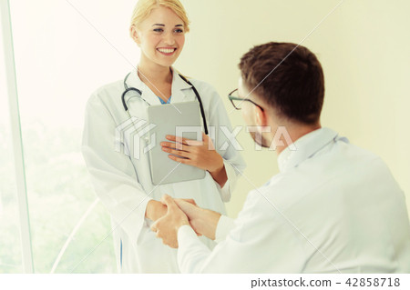 Doctor at hospital shakes hand with another doctor 42858718