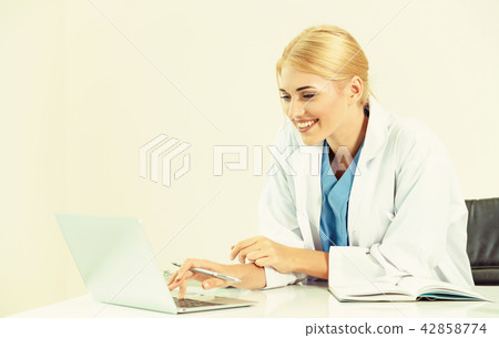 Doctor in hospital working on medical report. 42858774