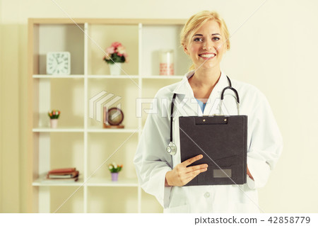 Young female doctor working in hospital office. 42858779
