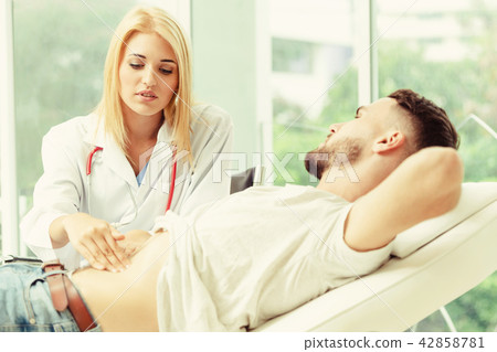 Woman Doctor and Male Patient in Hospital Office 42858781