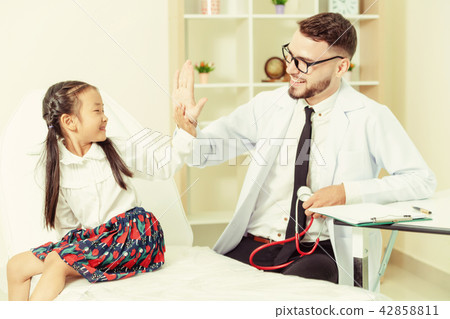Doctor examining little happy kid in hospital. 42858811