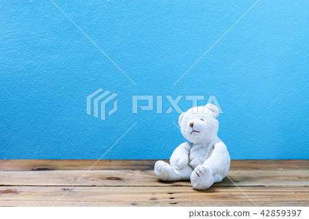 teddy bear on old wood ,blue wall background teddy bear on old wood ,blue wall background 42859397