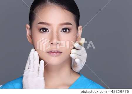 Beautiful Woman with Medical beauty Injection Treatment syringe over face before plastic surgery by doctor, Studio lighting white background isolated 42859776