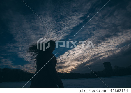silhouette of woman on a sky background 42862184