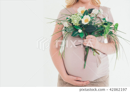 Pregnant woman with flowers on white background Pregnant woman with flowers on white background 42862197
