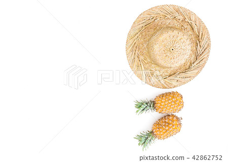 Tropical concept. Pineapple fruit and straw hat Tropical concept. Pineapple fruit and straw hat 42862752