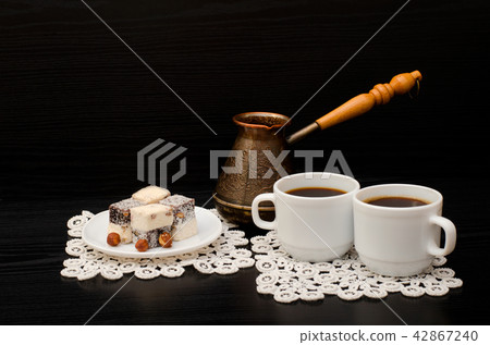 Two mugs of coffee, Turkish lokum with hazelnut Two mugs of coffee, Turkish lokum with hazelnut 42867240