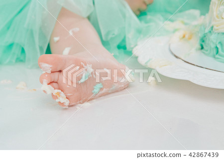 leg of baby food on white background.Feet and cake 42867439