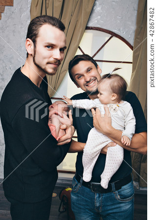 men in black with children in their arms 42867482