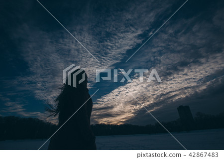 silhouette of woman on a sky background silhouette of woman on a sky background 42867483