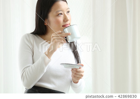 A woman drinking coffee A woman drinking coffee 42869830