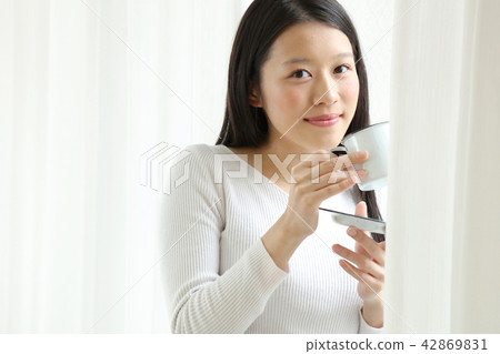 A woman drinking coffee A woman drinking coffee 42869831