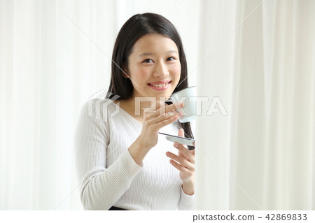 A woman drinking coffee A woman drinking coffee 42869833