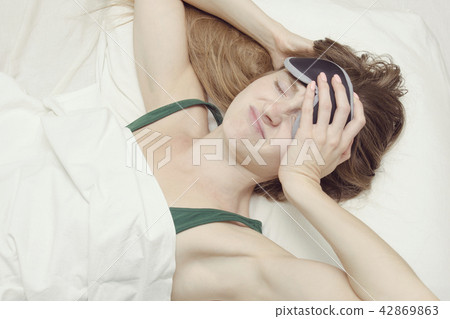 Young woman in a mask for sleep Young woman in a mask for sleep 42869863