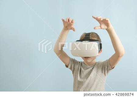 Boy in glasses of virtual reality. Blue background Boy in glasses of virtual reality. Blue background 42869874