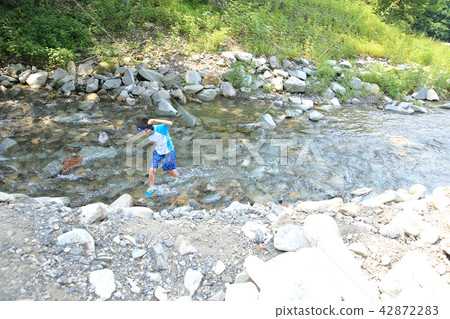 Children playing in the river Children playing in the river 42872283