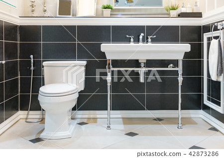 bathroom with bright tiles with toilet and sink. bathroom with bright tiles with toilet and sink. 42873286