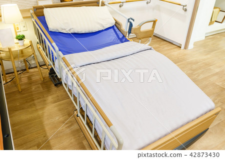 Empty hospital bed with medical equipment.  42873430