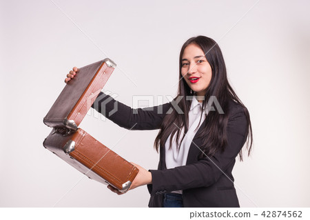 Happy brunette girl opening retro suitcase on white background 42874562