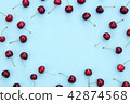 Fresh sweet cherries on blue background 42874568