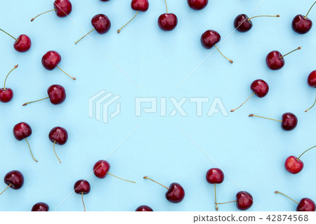 Fresh sweet cherries on blue background Fresh sweet cherries on blue background 42874568