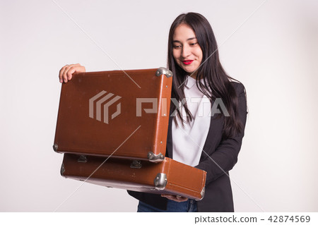 Beautiful asian girl with red lips staring into retro suitcase. Beautiful asian girl with red lips staring into retro suitcase. 42874569