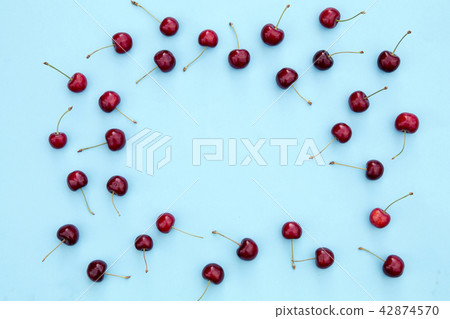 Fresh sweet cherries on blue background Fresh sweet cherries on blue background 42874570