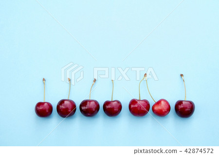 Fresh sweet cherries on blue background Fresh sweet cherries on blue background 42874572
