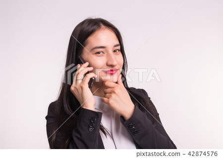 Beautiful asian girl in formal clothes with phone on white background 42874576