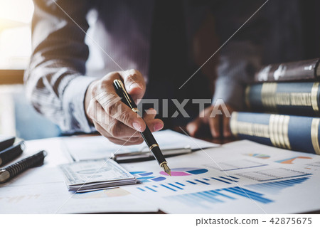 Businessman pointing at graph and chart to analysis use for plan 42875675