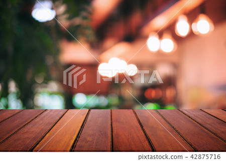 Empty wooden table and blurred background of abstract in front o Empty wooden table and blurred background of abstract in front o 42875716