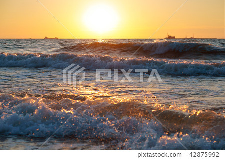 sunrise in the waves of the sea, sunset on the sea 42875992