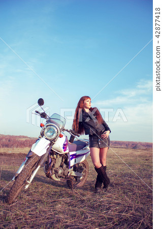 the girl next to the motorcycle the girl next to the motorcycle 42877418