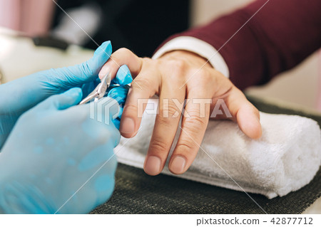 Female hands getting rid of cuticle Female hands getting rid of cuticle 42877712