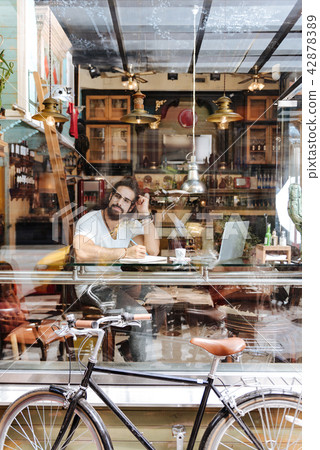Pleasant creative man looking into the window 42878389
