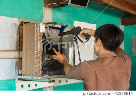 Technician are servicing repairing air conditioner Technician are servicing repairing air conditioner 42878614
