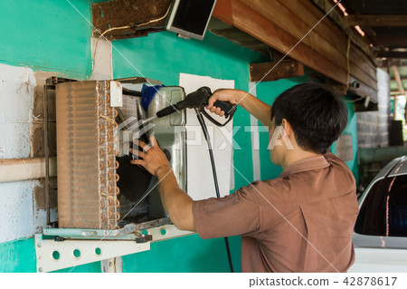 Technician are servicing repairing air conditioner 42878617