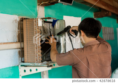 Technician are servicing repairing air conditioner Technician are servicing repairing air conditioner 42878618