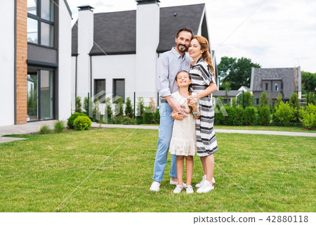 Cheerful nice family standing together Cheerful nice family standing together 42880118
