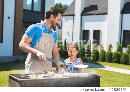 Pleasant nice man standing together with his daughter 42880301
