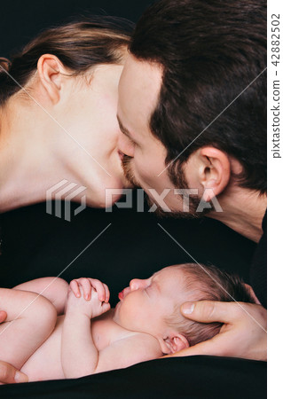 newborn baby lying on the hands of parents newborn baby lying on the hands of parents 42882502