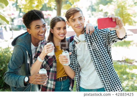 Modern beaming students making selfie together 42883425