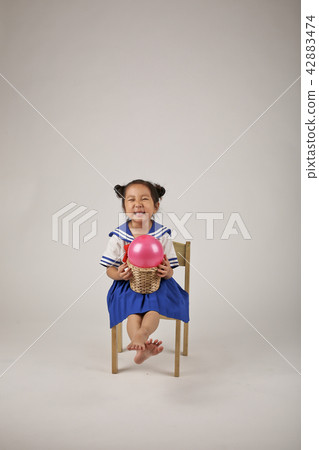 A child playing with a balloon A child playing with a balloon 42883474