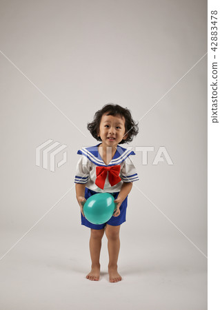 A child playing with a balloon A child playing with a balloon 42883478