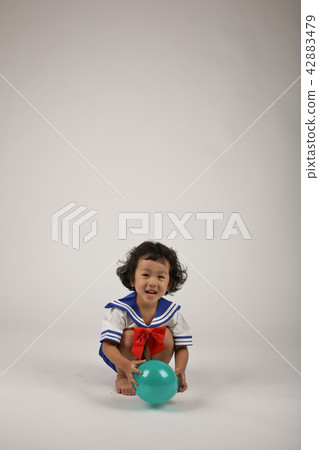 A child playing with a balloon A child playing with a balloon 42883479