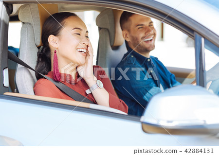 Pleasant nice woman touching her cheek Pleasant nice woman touching her cheek 42884131
