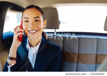 Joyful attractive businesswoman having a phone conversation 42884669
