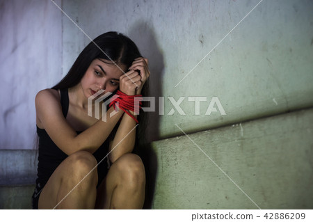 Depressed hostage woman tied by rope Depressed hostage woman tied by rope 42886209