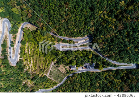 Winding road serpentine from a high mountain pass in the mosel village Brodenbach Germany Aerial Winding road serpentine from a high mountain pass in the mosel village Brodenbach Germany Aerial 42886363